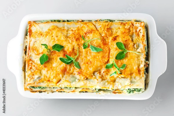 Obraz Spinach lasagna with basil and oregano Isolated.