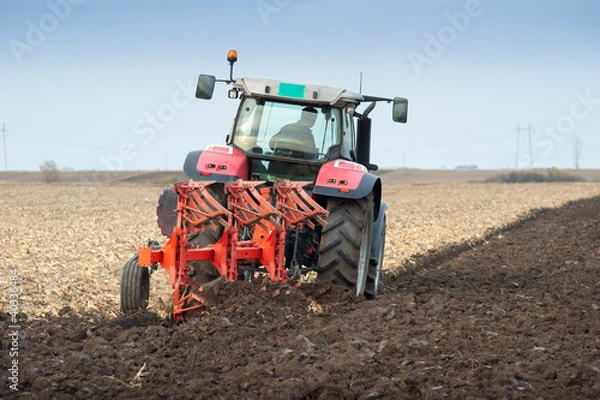 Fototapeta Tractor plowing the fields