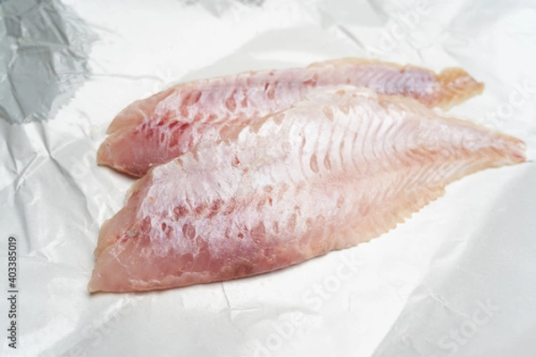 Obraz Two fresh redfish fillets on white wrapping paper