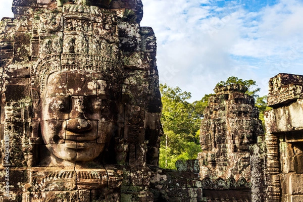 Obraz Portrait of a Face tower in the Bayon temple in Angkor with forest background. Cambodia. Horizontal view.