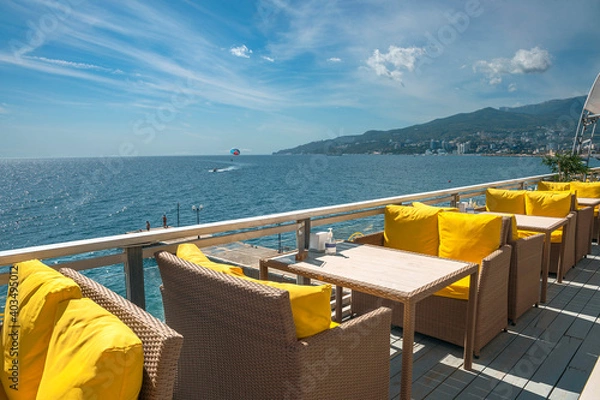 Fototapeta a cafe on the Black Sea coast in a recreation area of a Russian resort with wicker chairs and tables
