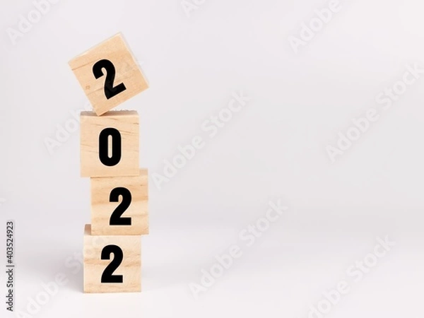 Fototapeta Text 2022 on wooden cubes isolated on white background.Business concept.