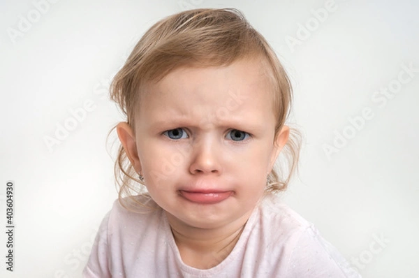 Fototapeta Little baby with sad expression in face