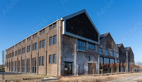 Fototapeta Dark brick facade of an old abandoned factory.