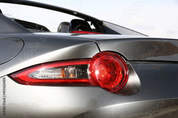Fototapeta Close-up  car rear tail-lamp with a brakelight stop signal.