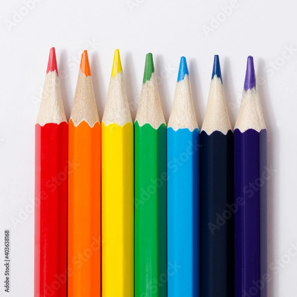 Fototapeta Multi-colored pencils on a white background.