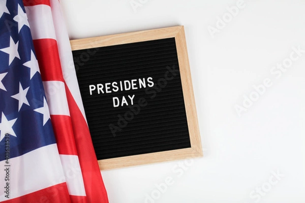 Fototapeta black letter board with text president day and American flag on white background. top view flat lay copy space 