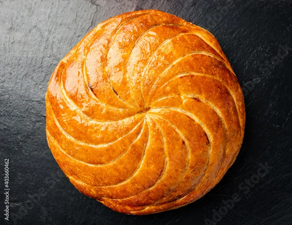 Fototapeta Epiphany cake or galette des rois in French on black slate background
