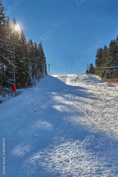 Fototapeta Empty ski slope with sun rays