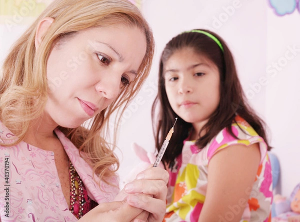 Fototapeta doctor checking her syringe before putting the patient