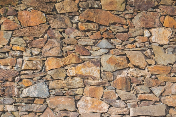 Obraz Old stone rock wall surface texture with grass. Close up detail. Pattern abstract background.