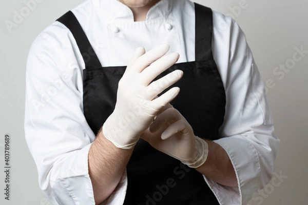 Obraz Chef putting latex gloves on. Closeup.