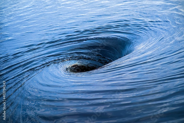 Fototapeta The raging whirlpool. Huge whirlpool on a water surface