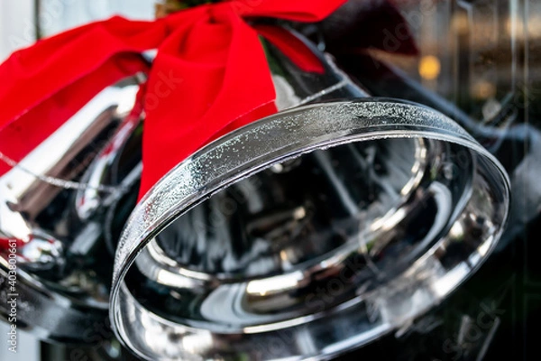 Obraz Close up of Silver Christmas Bells with a vivid Red Bow towards the top left hand side of the image.