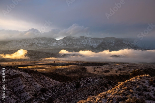 Obraz Winter storm clouds settle in a desert valley at sunset, Southern Utah