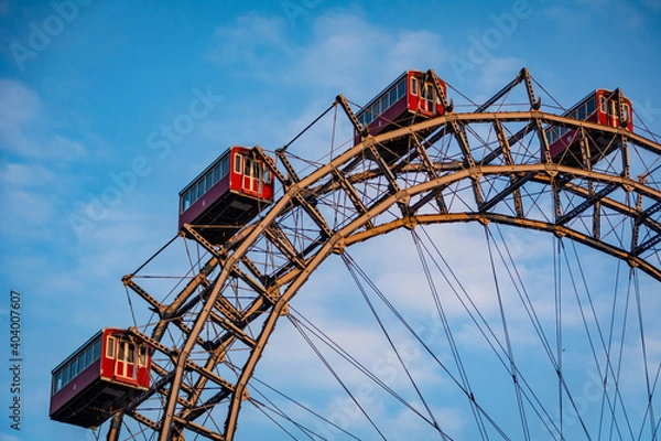 Fototapeta Historic Ferris wheel of the famous Vienna Prater Park with its wooden red carriages. One of the main sighting points in Vienna, Austria 