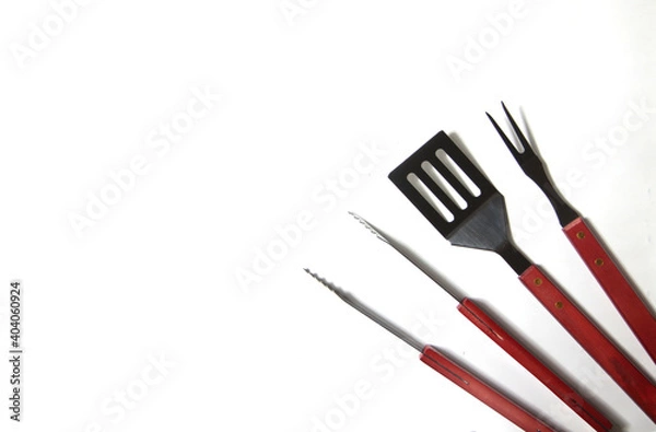 Obraz BBQ instruments kit - tongs, spatula, fork - close up isolated on white background flat lay