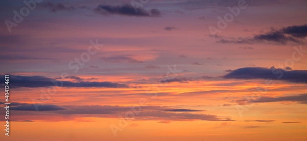 Fototapeta Natural color dramatic dawn or dusk sky with painterly yellow, pink and blue clouds with horizon, taken with wide angle 35 mm lens for sky replacement
