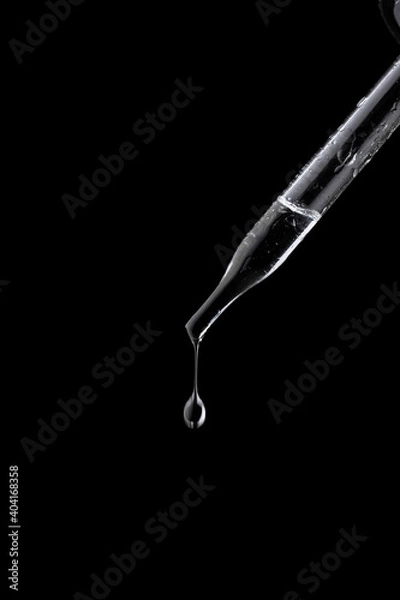 Obraz Glass pipette with drop on black background