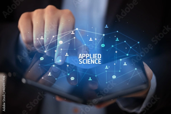 Fototapeta Businessman holding a foldable smartphone with APPLIED SCIENCE inscription, new technology concept