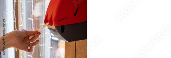 Fototapeta the hand receives a ticket with the queue number from the machine