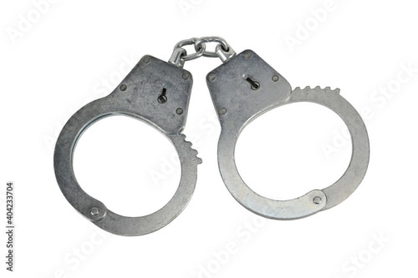 Fototapeta Police handcuffs isolated on white background without shadows. Pair of real metal handcuffs macro close-up high resolution.