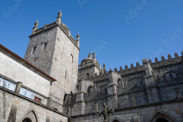 Fototapeta Porto cathedral seen from the inner courtyard. Building made of stone Blue sky.