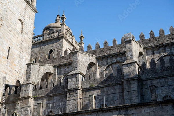 Fototapeta Porto cathedral seen from the inner courtyard. Building made of stone Blue sky.