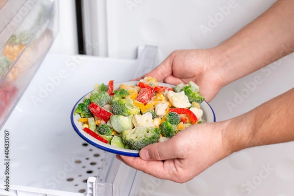 Fototapeta Frozen vegetables: broccoli, corn, pea, cauliflower, peppers, green beans on plate in the freezer