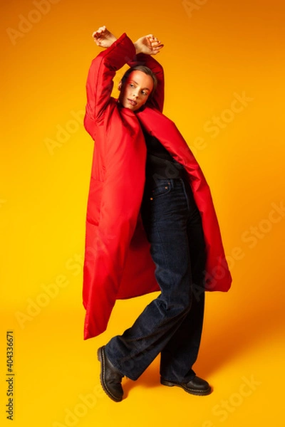 Fototapeta Female model in baggy coat and dancing