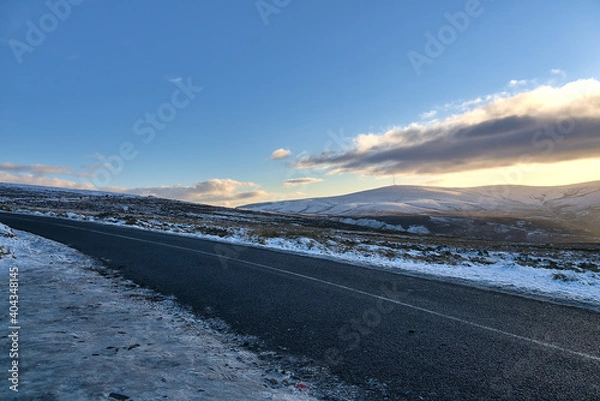 Fototapeta Beautiful diagonal winter view of Old Military Road (R115) traversing along the ridge of Wicklow Mountains, Co. Wicklow, Ireland. Leading lines. Irish winter