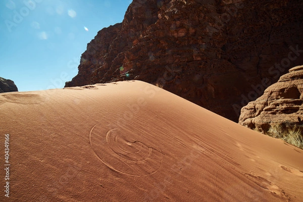 Fototapeta Perfect circle footprint done by the wind in a wadi rum desert dune