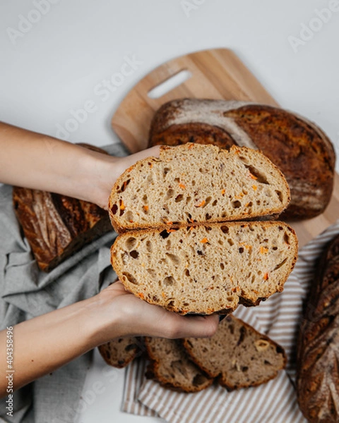 Fototapeta Fresh loaves of bread on a white table