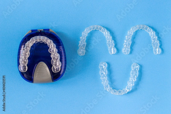 Obraz Invisalign braces or invisible retainer on blue background