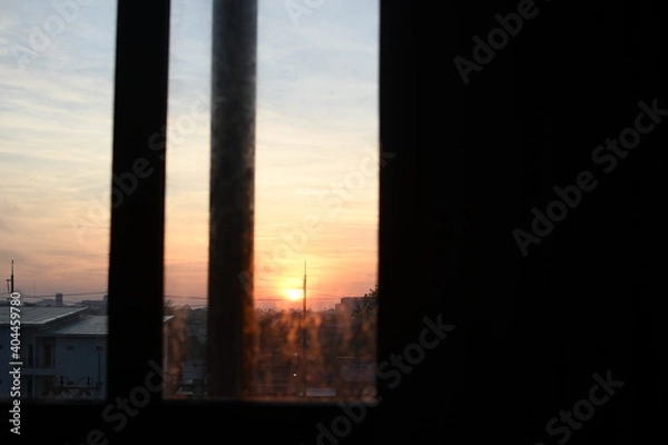 Obraz sunset over the city with orange sky beautiful view