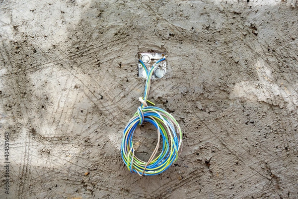 Fototapeta Freshly laid concrete wall with wet scratches and colored electrical cables,, abstract background, texture. Stock Photo.