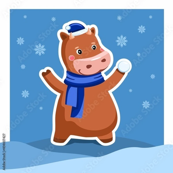 Fototapeta Funny bull plays in the snow. A Christmas character.