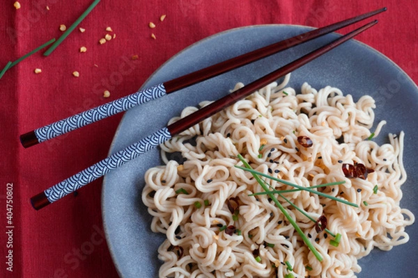 Fototapeta Instant noodles in a plate with chopsticks. Top view. Noodles photography