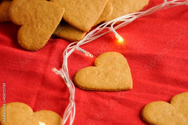 Fototapeta Valentine's day cookies background isolated on red with decorative lights. Valentine's day and love concept. Selective focus