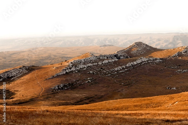 Fototapeta view of the mountains covered with dried orange grass