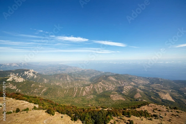 Fototapeta view of the coast with the sea and mountains against the blue sky from a bird's eye view