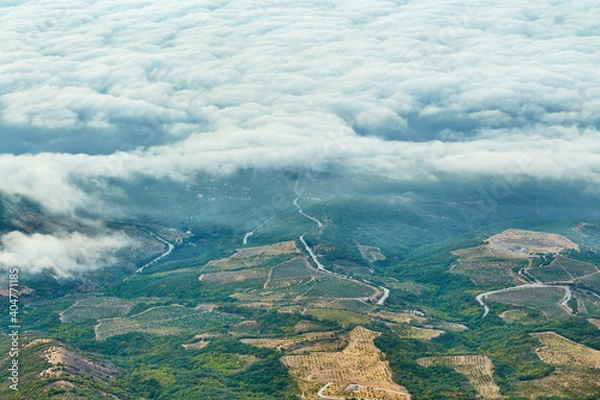 Fototapeta bird's eye view of the village with hills and clouds