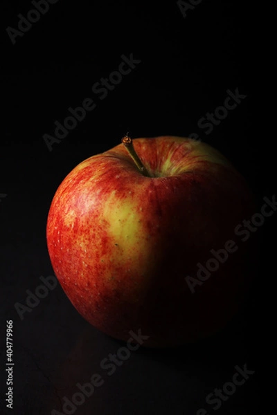 Obraz An apple against black background