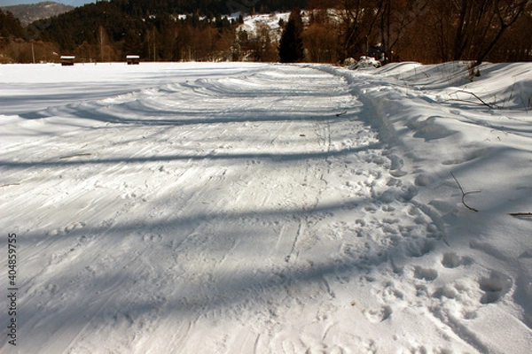 Fototapeta Snow covered road in countryside