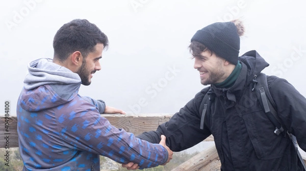 Fototapeta the hikers shake hands like the ancient Romans