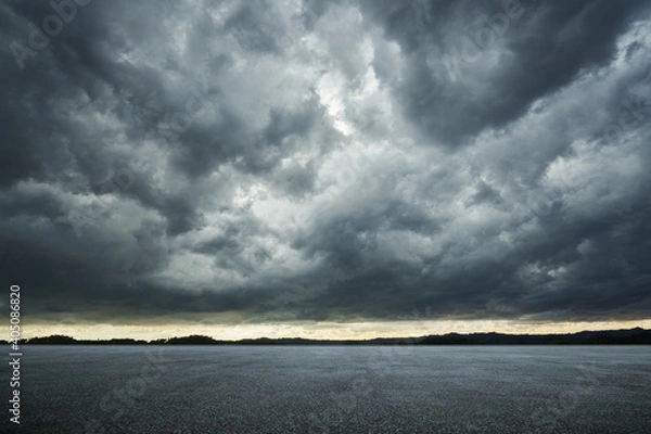 Obraz Empty asphalt ground floor with dramatic windstorm clouds sky .