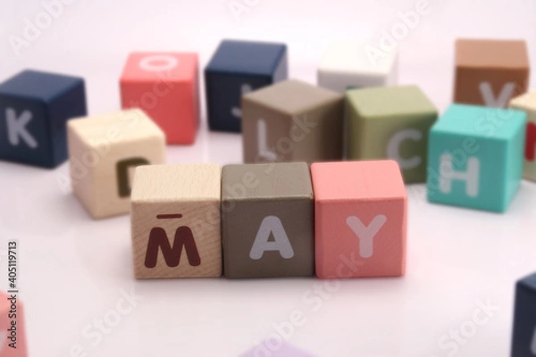 Fototapeta Cubes each with a letter on it written the word may