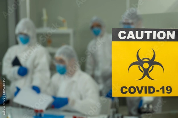 Obraz Group of four Asian medical scientists wearing PPE protective suits working with blood sample in laboratory.  Healthcare and medicine concept. virus pandemic concept. 