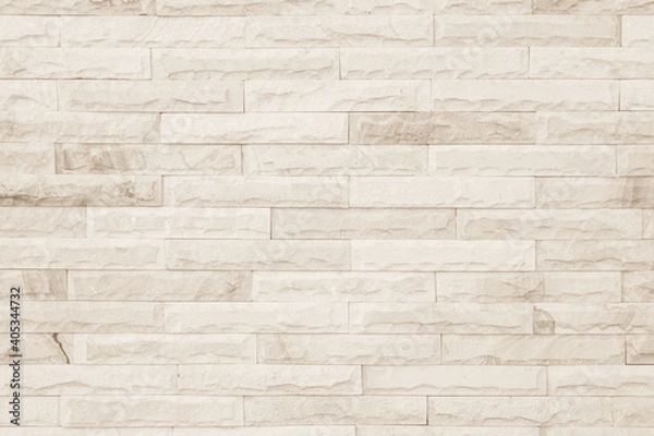 Fototapeta Empty background of wide cream brick wall texture. Beige old brown brick wall concrete or stone textured, wallpaper limestone abstract flooring/Grid uneven interior rock. Home decor design backdrop.