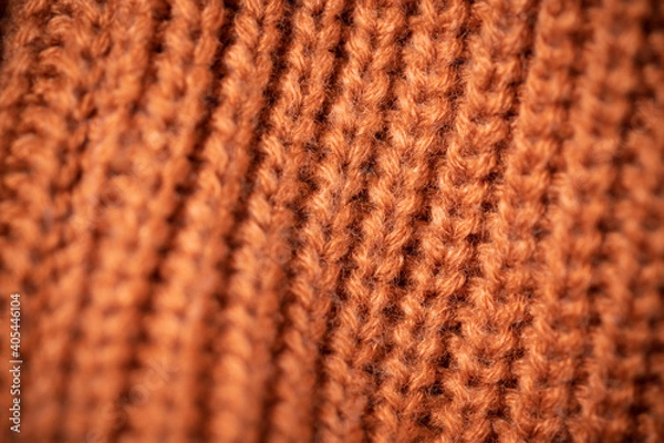 Fototapeta Orange wool scarf background texture. Macro photo with selective focus.